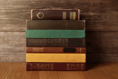 Image of Stack of old hardcover books on wooden table