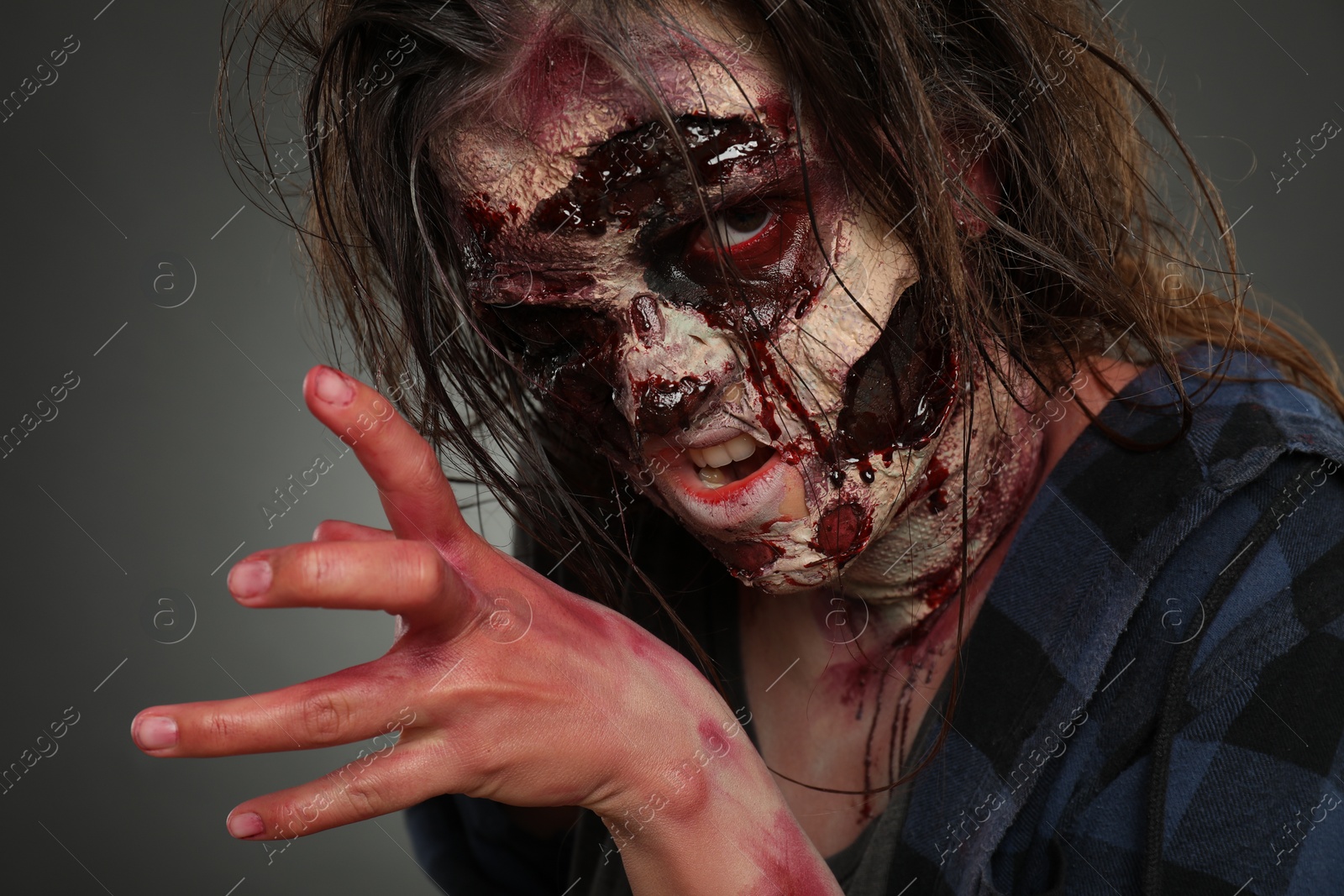 Photo of Scary zombie on dark background, closeup. Halloween monster