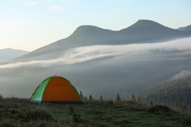 Photo of Camping tent in mountains on early morning