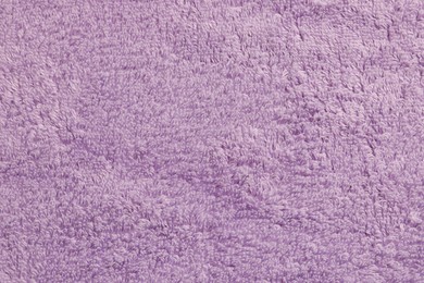 Photo of Soft pale purple towel as background, top view