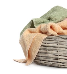 Towels in wicker basket on white background