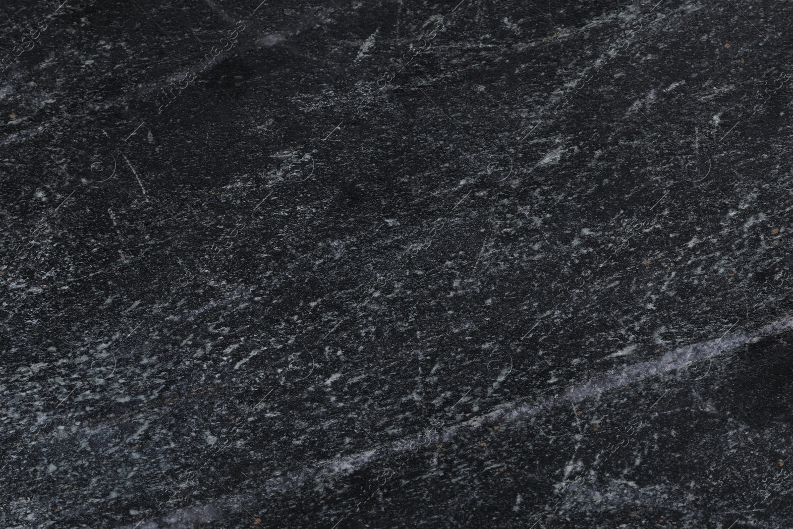 Photo of Texture of black marble surface as background, closeup