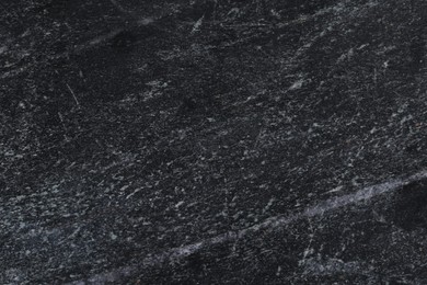 Photo of Texture of black marble surface as background, closeup
