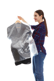 Photo of Young woman holding hanger with dress on white background. Dry-cleaning service