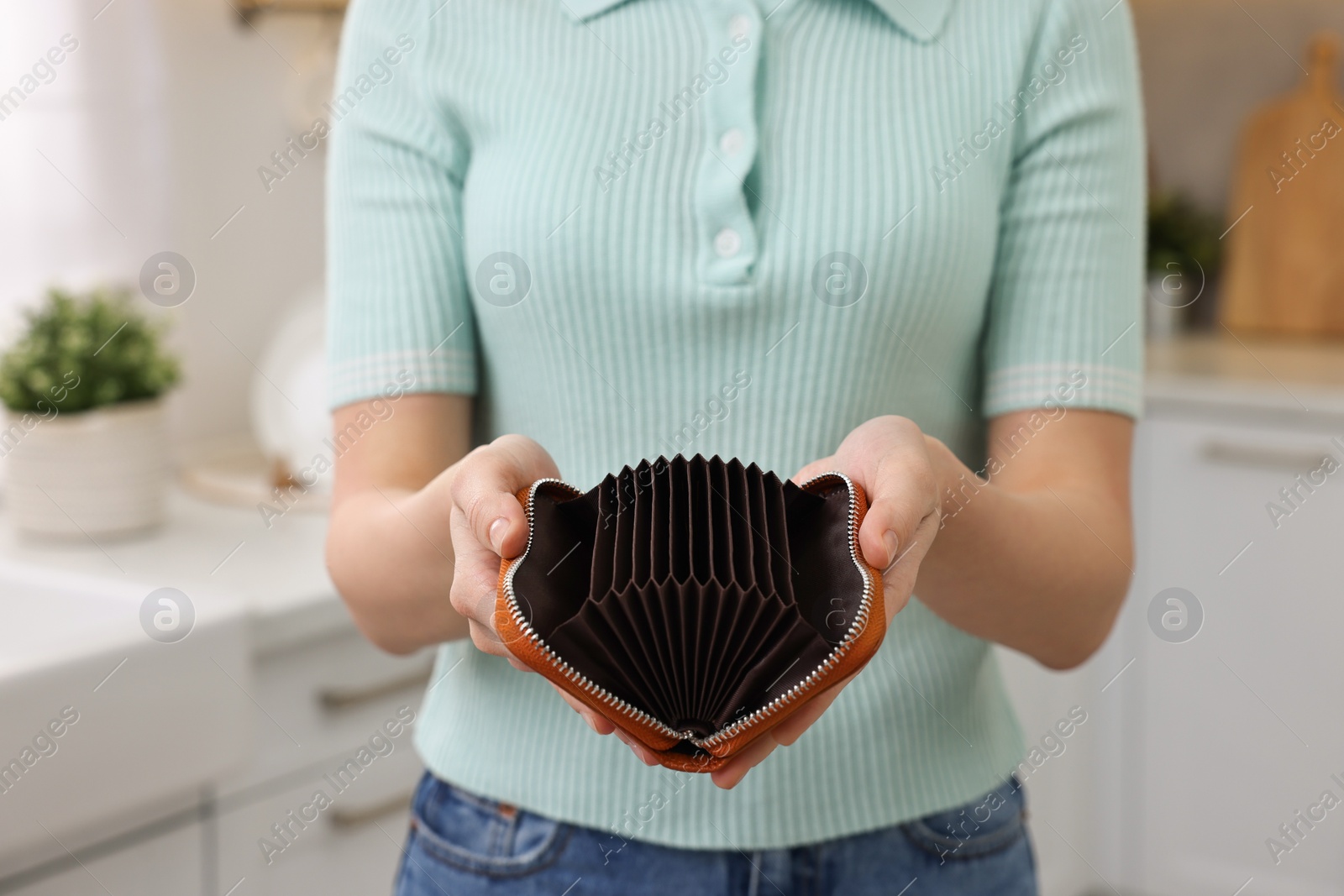 Photo of Woman with empty wallet at home, closeup