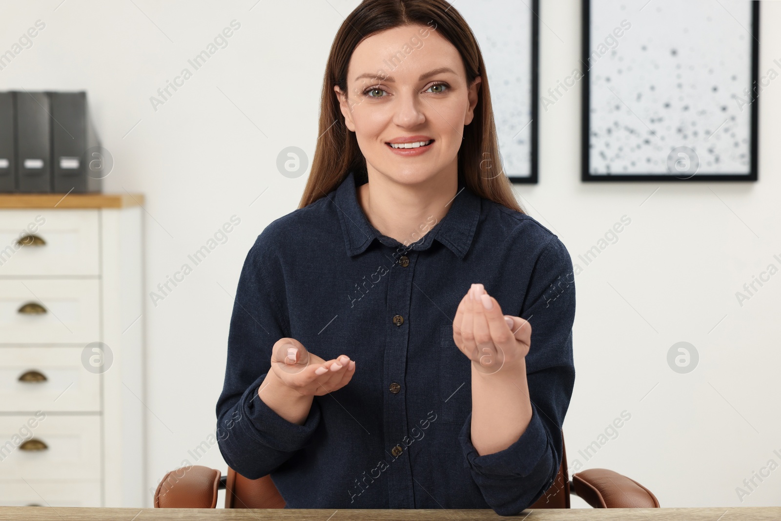 Photo of Woman having video chat at table in office, view from web camera