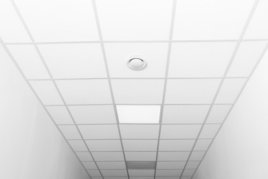 White ceiling with modern lighting in office