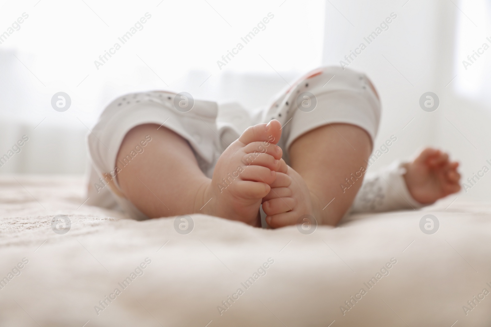 Photo of Little baby on brown blanket at home, closeup