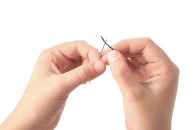 Closeup view of woman threading needle on white background