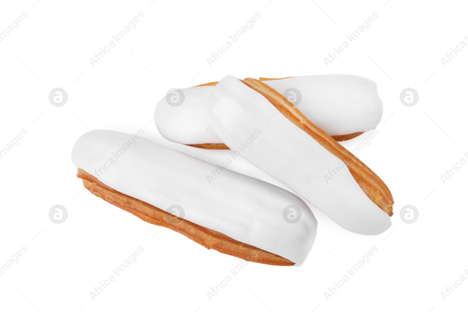 Photo of Three delicious eclairs covered with glaze isolated on white, top view
