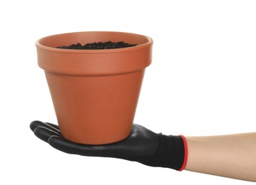 Woman holding terracotta flower pot filled with soil on white background, closeup