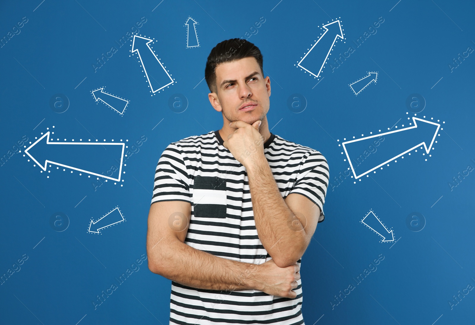 Image of Choice in profession or other areas of life, concept. Making decision, thoughtful man surrounded by drawn arrows on blue background