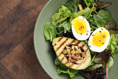 Photo of Healthy dish high in vegetable fats on wooden table, top view. Space for text