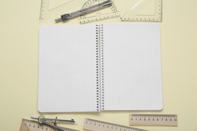 Flat lay composition with different rulers and compasses on yellow background