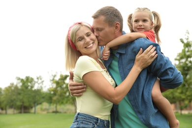 Photo of Happy family spending time together in park on sunny summer day