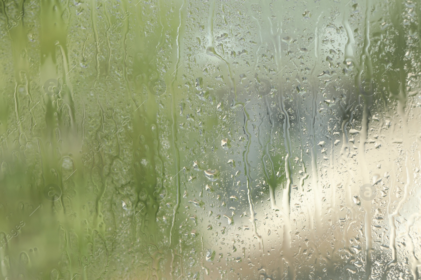 Photo of Window glass with raindrops as background, closeup