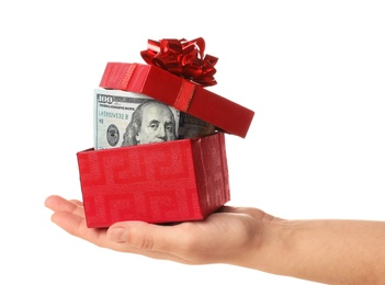 Photo of Woman holding gift box with dollar banknotes on white background, closeup