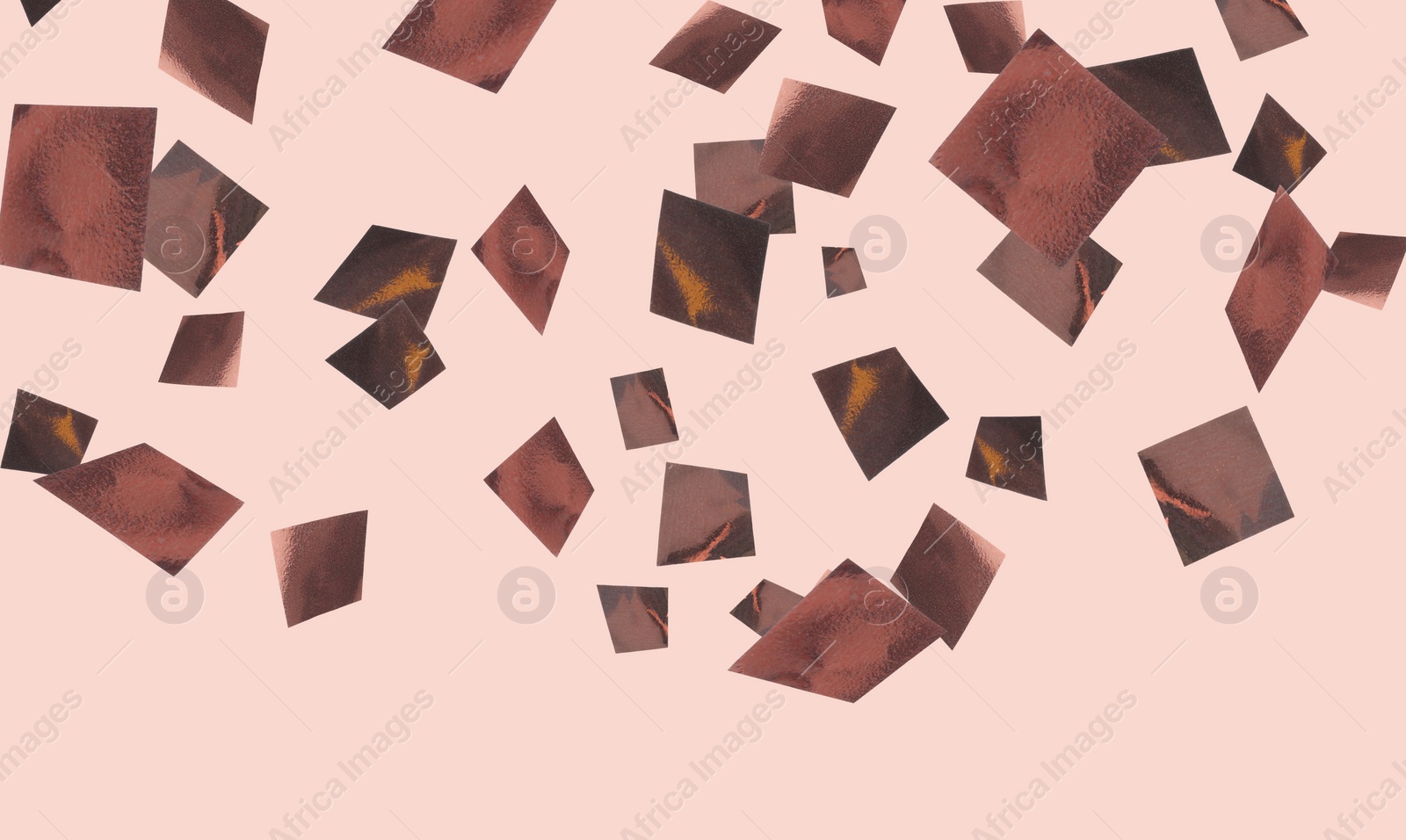 Image of Shiny bronze confetti falling on dusty pink background. Banner design