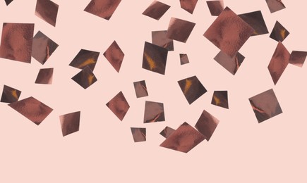 Shiny bronze confetti falling on dusty pink background. Banner design