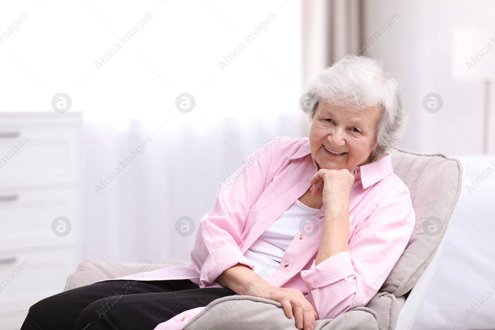 Photo of Portrait of beautiful grandmother in living room