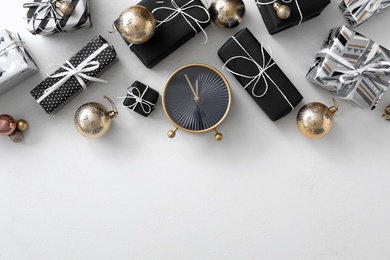 Photo of Flat lay composition with alarm clock and Christmas decor on white background, space for text. New Year countdown