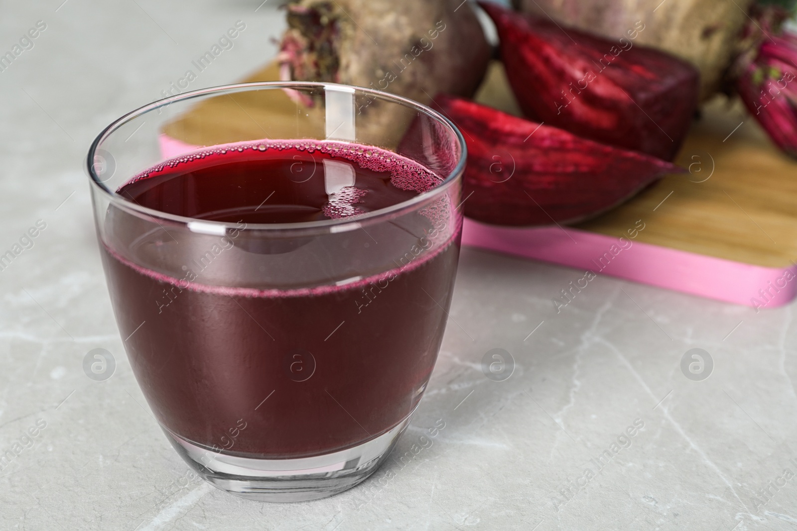 Photo of Glass with fresh healthy beet juice on table