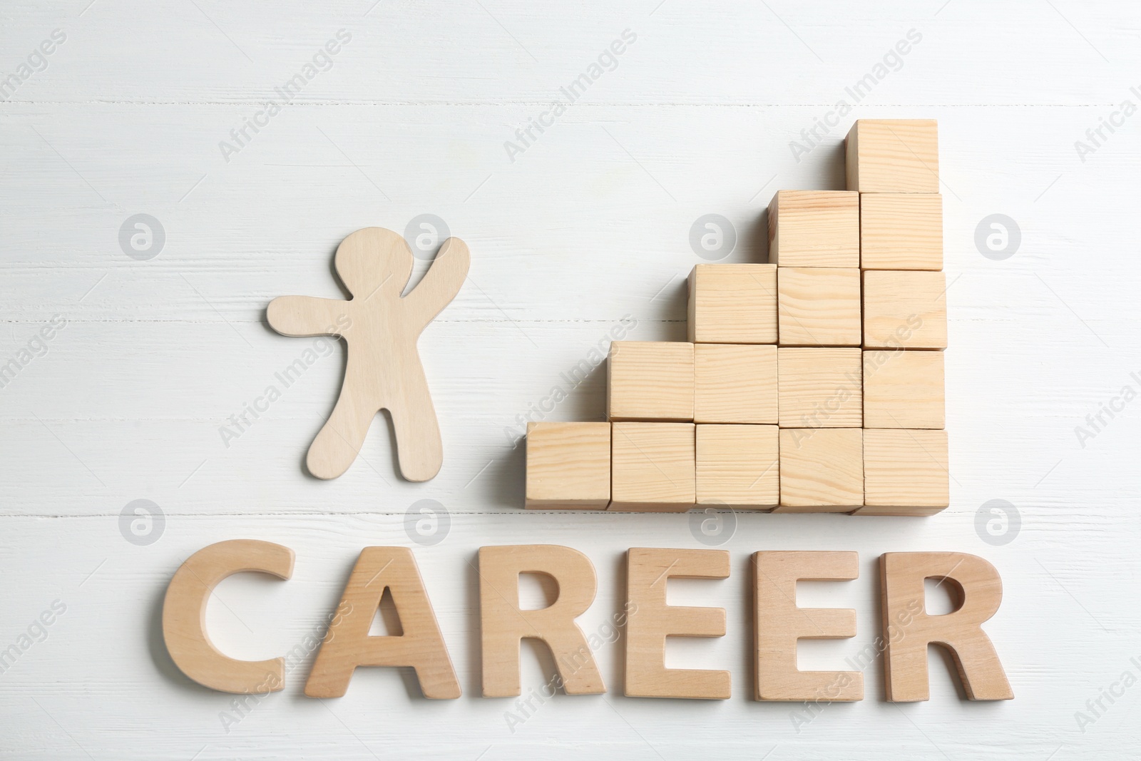 Photo of Human figure, stairs made of blocks and word CAREER on white wooden background, flat lay. Promotion concept