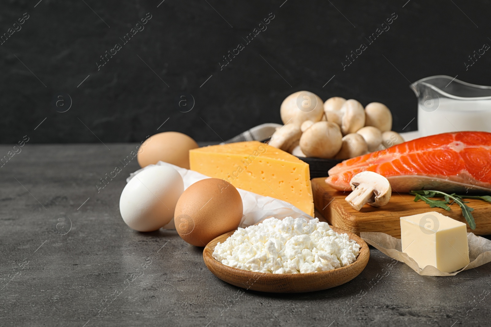 Photo of Fresh products rich in vitamin D on grey table