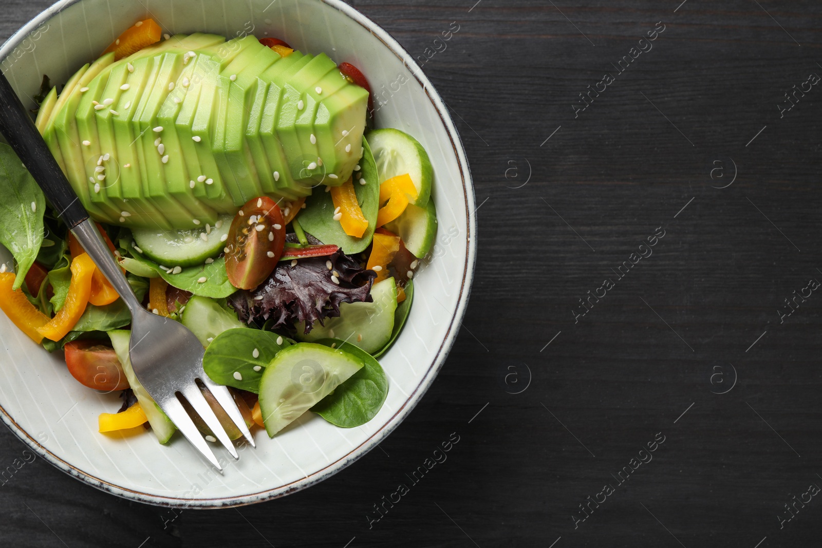 Photo of Healthy dish high in vegetable fats on black wooden table, top view. Space for text