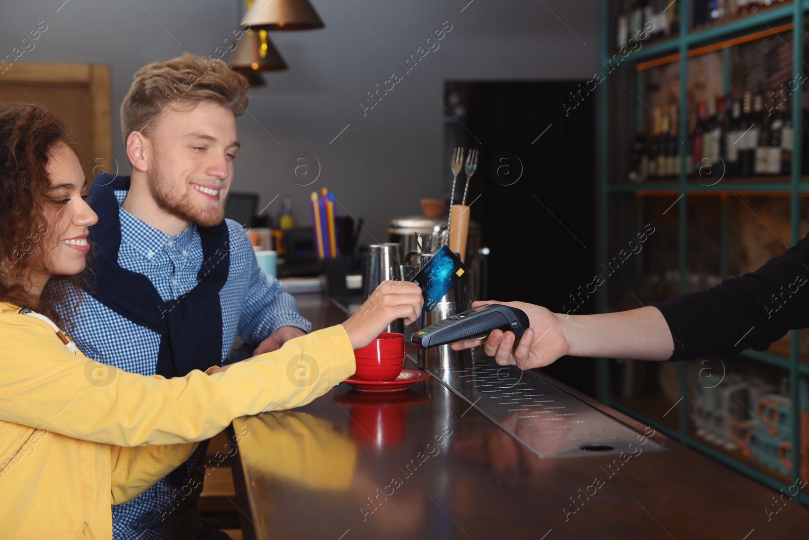 Photo of Clients using credit card machine for non cash payment in cafe