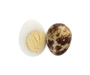 Unpeeled and peeled hard boiled quail eggs on white background, top view