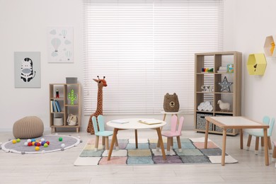 Child`s playroom with different toys and modern furniture. Stylish kindergarten interior