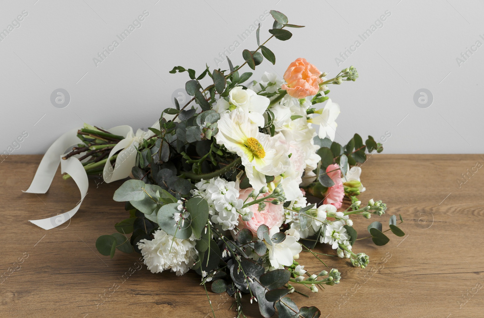 Photo of Bouquet of beautiful flowers on wooden table