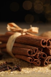 Photo of Different spices on table against black background, closeup