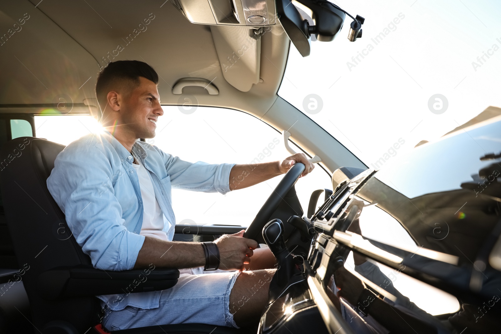 Photo of Handsome man in car on road trip
