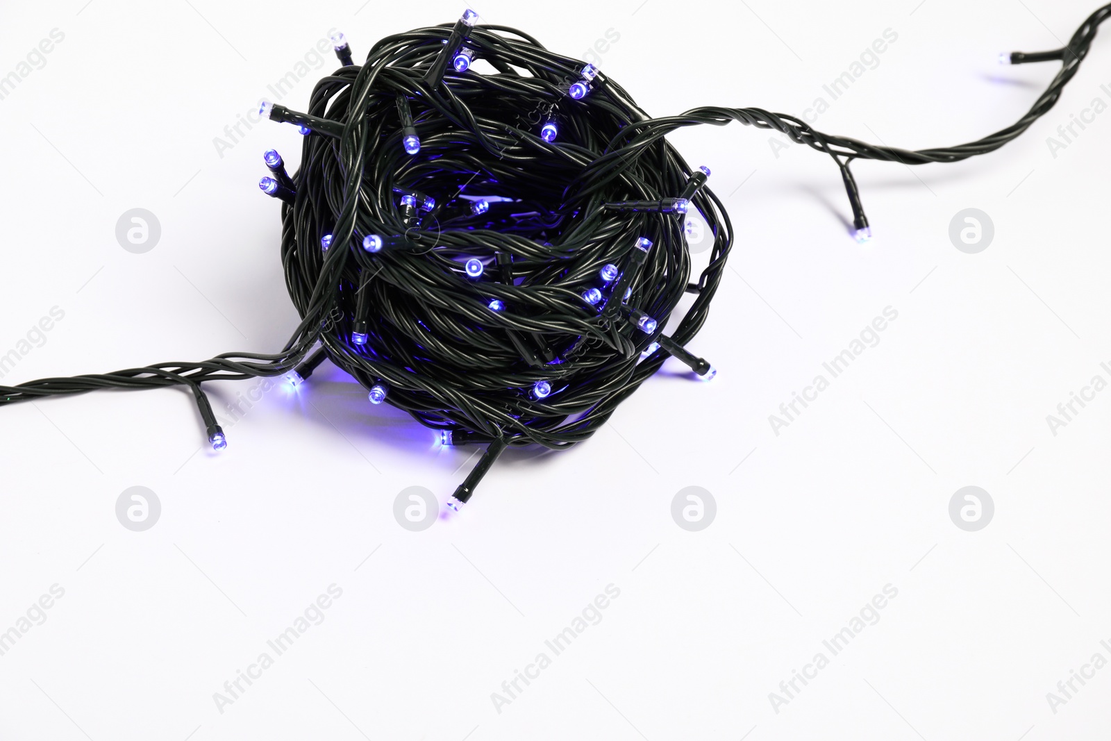 Photo of Beautiful Christmas lights on white background, top view