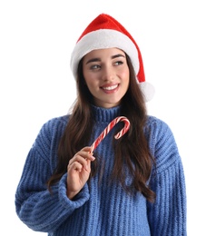 Beautiful woman in Santa Claus hat holding candy cane on white background