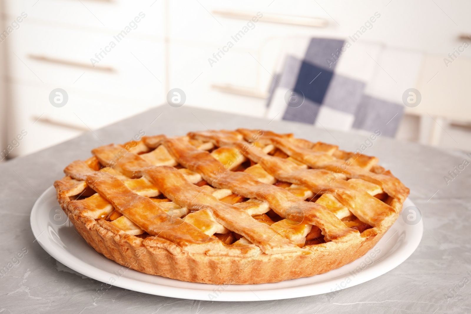 Photo of Delicious fresh peach pie on grey kitchen table, closeup