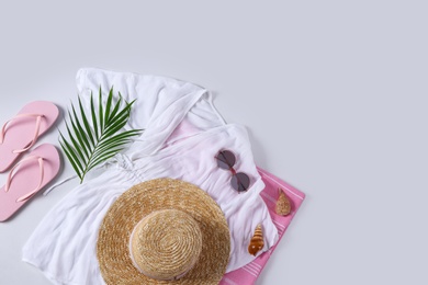 Flat lay composition with beach accessories on white background. Space for text