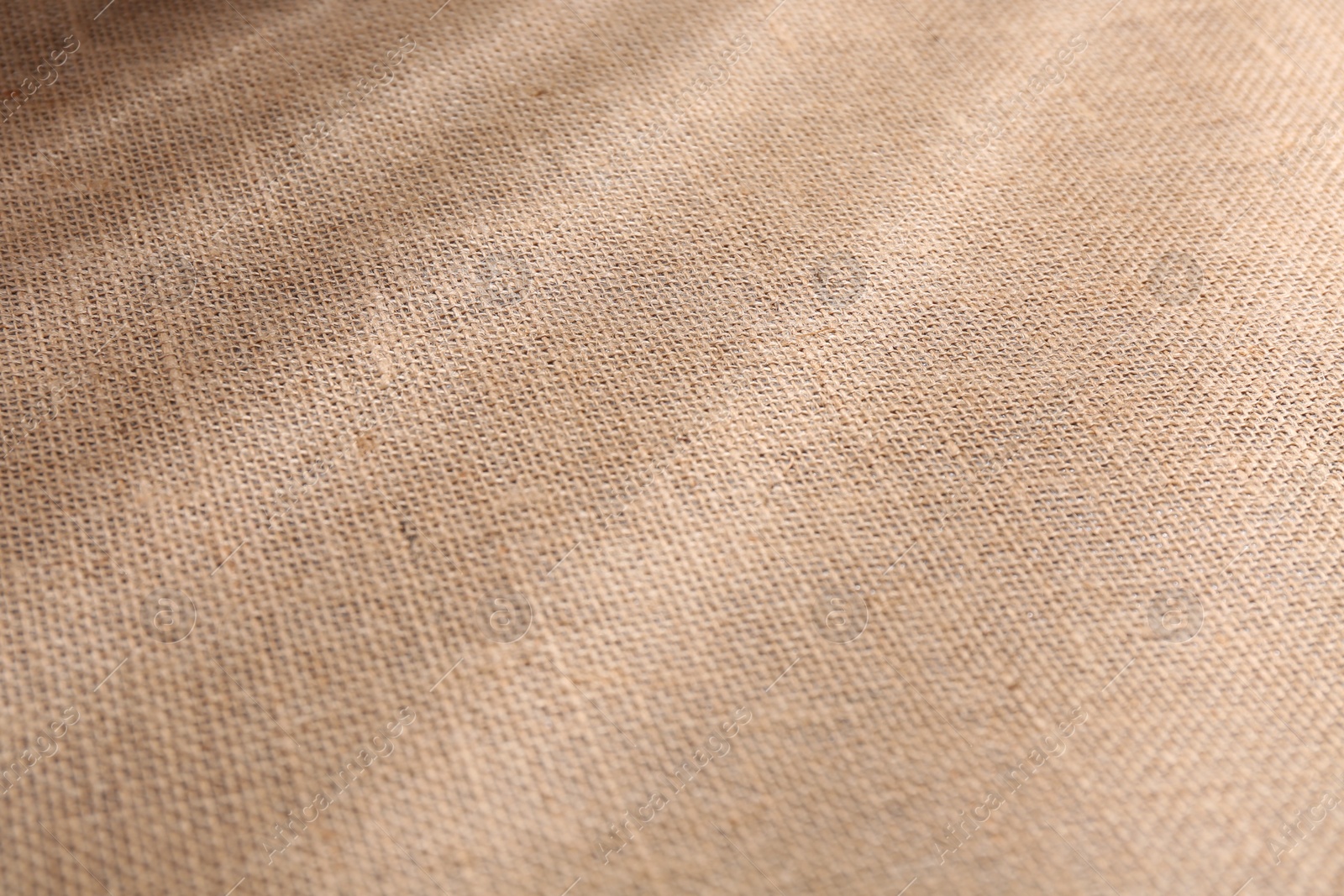 Photo of Brown burlap fabric as background, closeup view