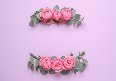 Photo of Wreathes made of beautiful flowers and green leaves on violet background, flat lay. Space for text