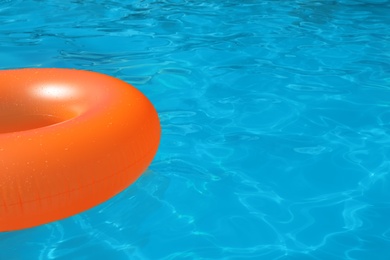 Photo of Inflatable ring floating in swimming pool on sunny day. Space for text