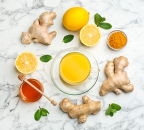 Photo of Flat lay composition with immunity boosting drink and ingredients on marble table