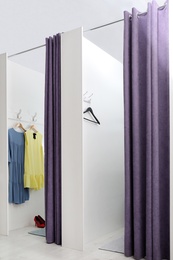 Photo of Empty dressing rooms in fashion store. Stylish interior