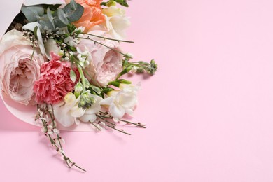 Photo of Bouquet of beautiful flowers on pink background, space for text