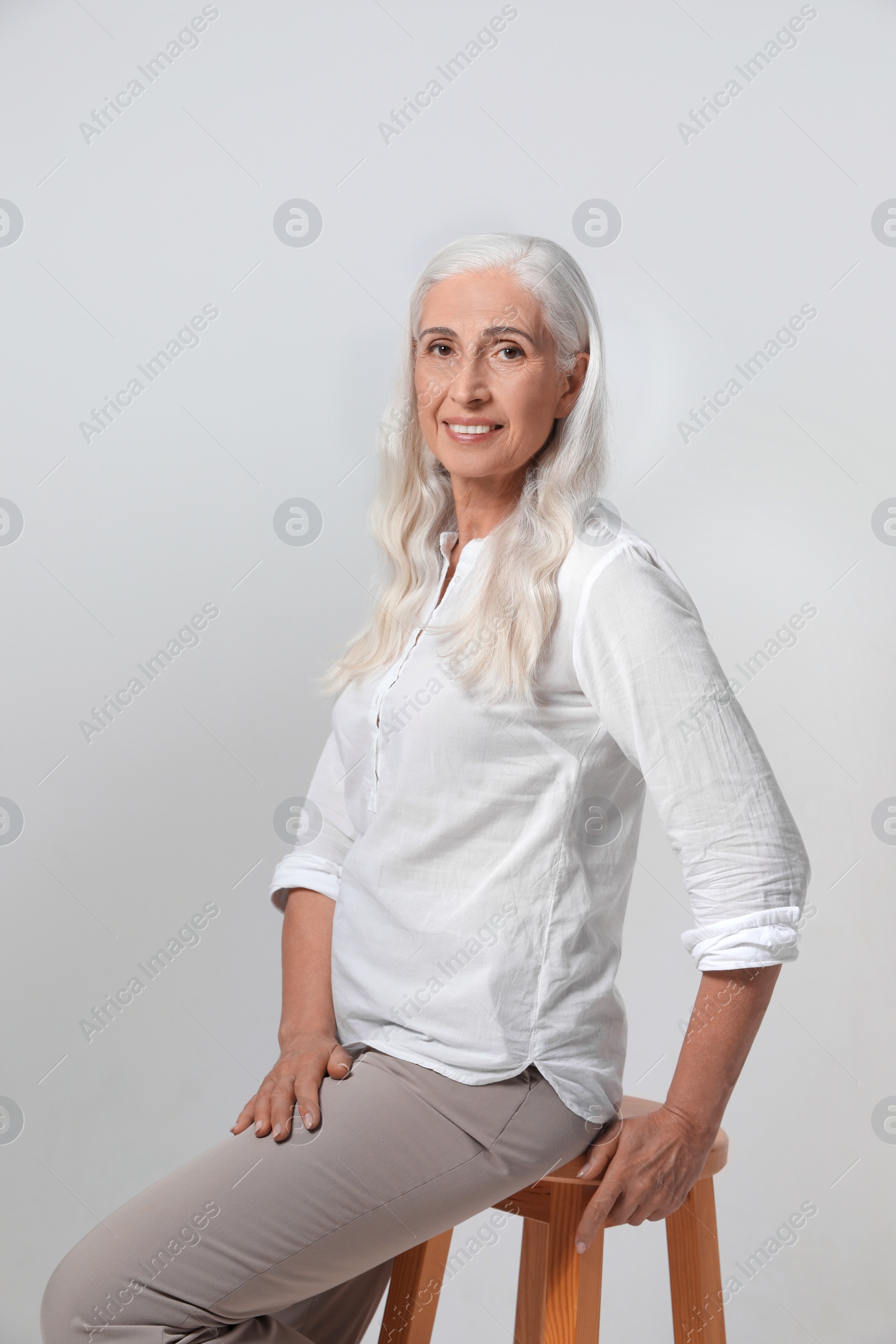 Photo of Portrait of beautiful mature woman on light background