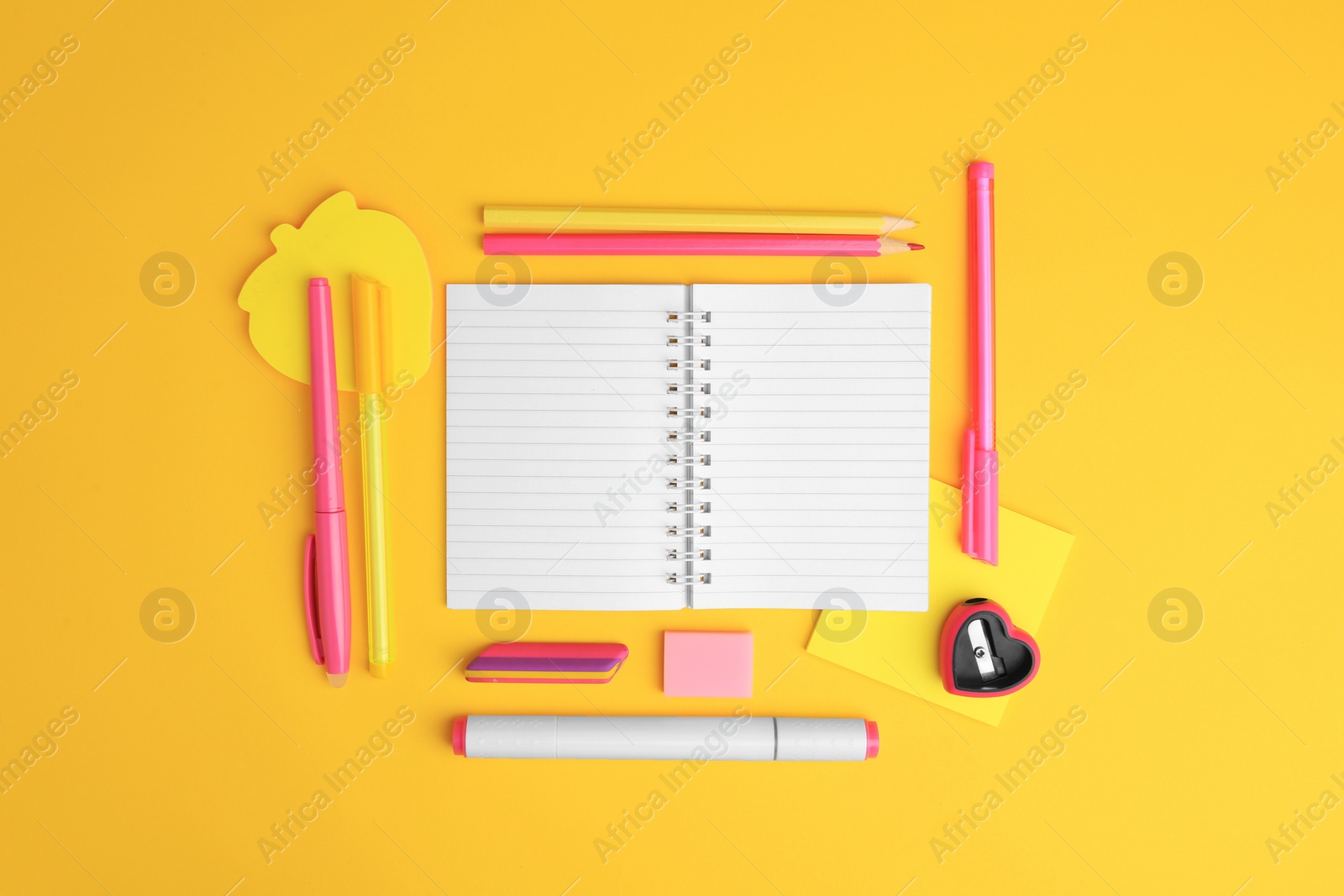 Photo of Flat lay composition with open notebook and different school stationery on yellow background, space for text. Back to school