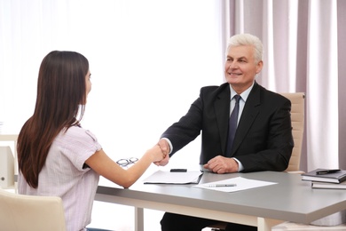 Photo of Young woman having meeting with lawyer in office