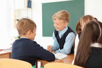 Little children in classroom. Stylish school uniform