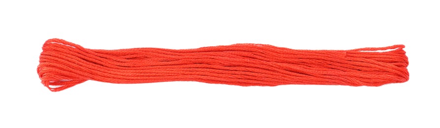 Bright coral embroidery thread on white background